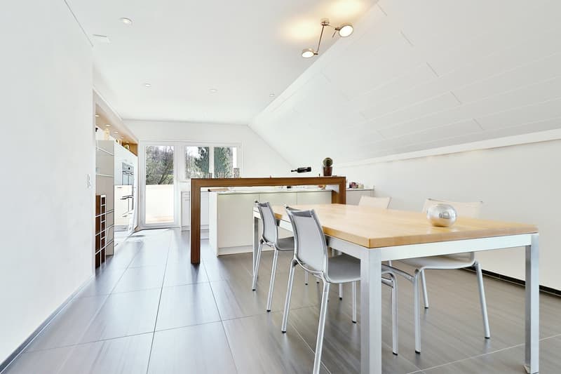 modern, white walls, wooden floor, white table, gray chairs, open to kitchen