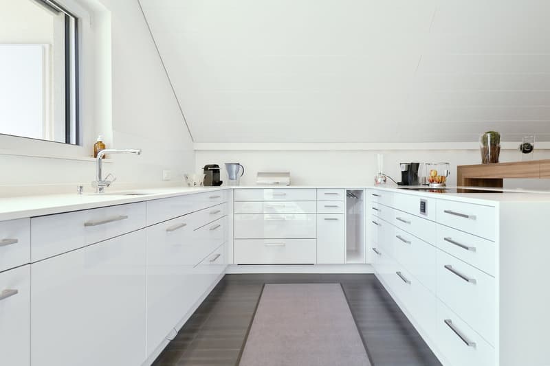 modern white kitchen with modern appliances, cabinets, drawers, modern faucet, white countertop