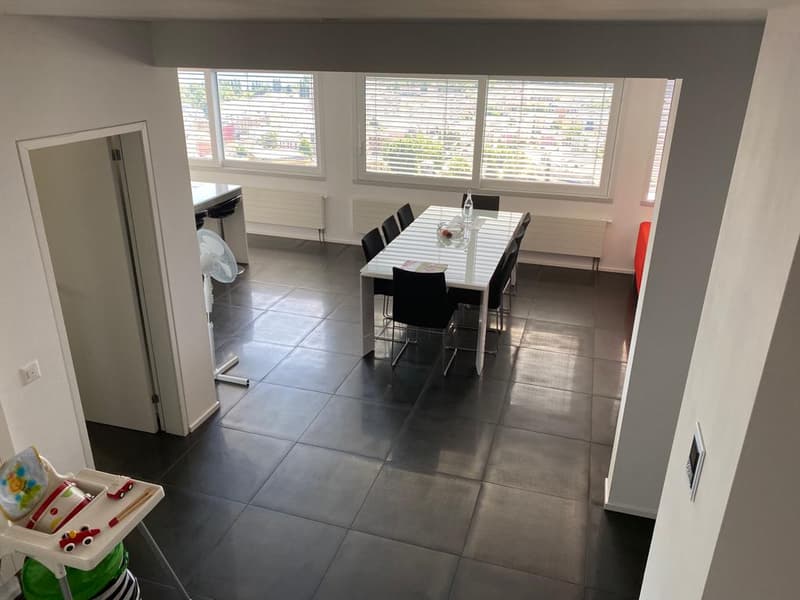 dining room with large table and chairs, gray tiles, white walls, large windows, white ceiling