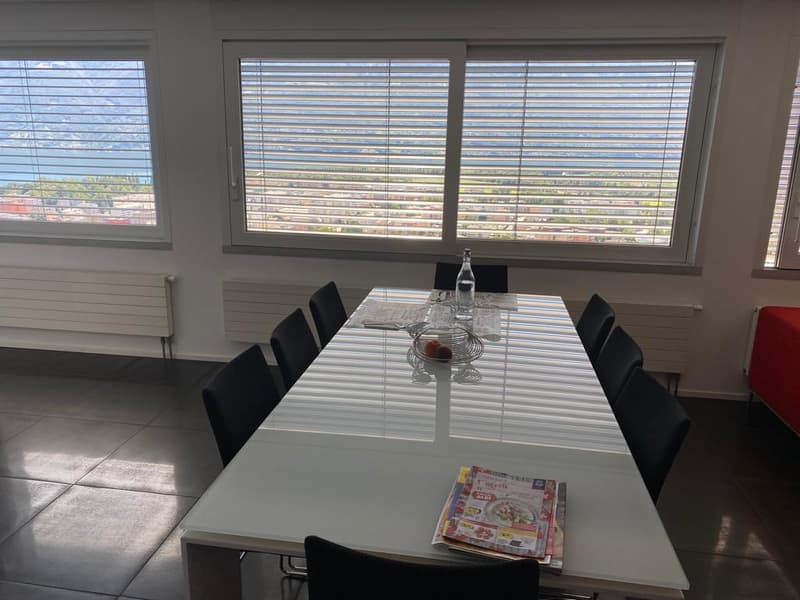 large dining table with chairs, large windows with view, radiators on wall, white tiled floor