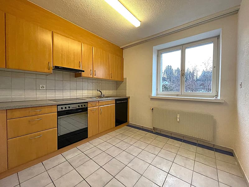 kitchen with wooden cabinets, tiled floor, white walls, window, gas stove, oven, sink, dishwasher, radiator