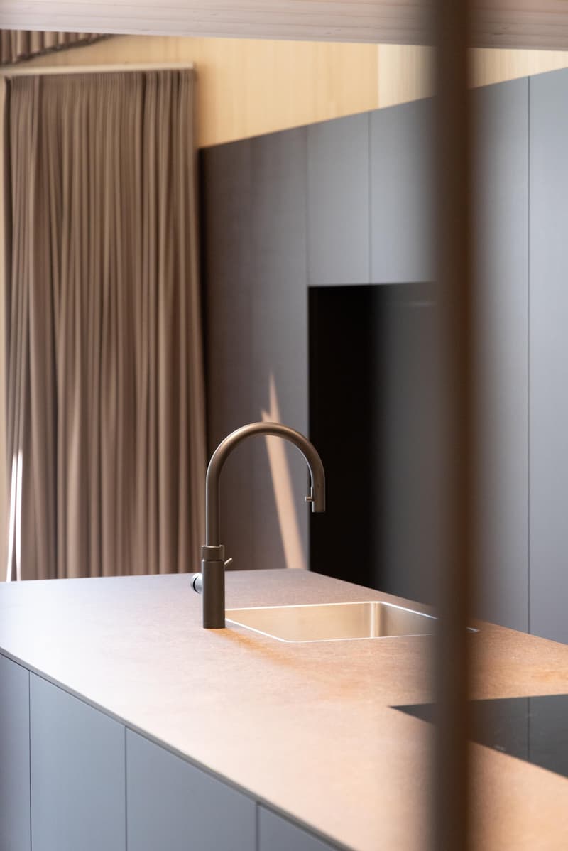 modern kitchen sink with chrome faucet, stainless steel sink, dark brown cabinets, wooden ceiling