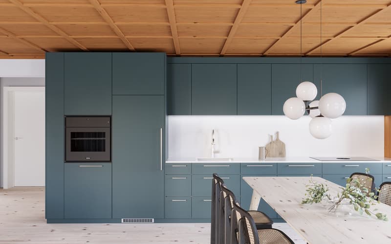 a dining area in a kitchen with wooden table and green cabinets
