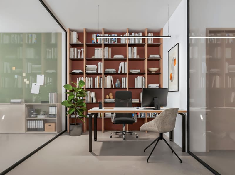 modern office with desk, chairs, bookshelves, computer, plant, and framed picture