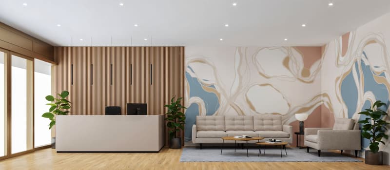 Reception area with wooden desk, beige sofa, wooden floor, abstract wall art, plants, lamps, and a glass wall.