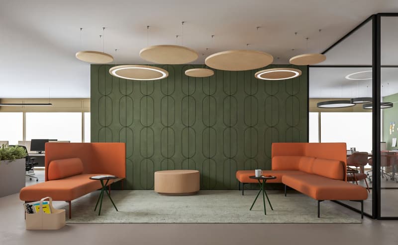 modern office lounge with green wall, orange couches, round tables, round lamps