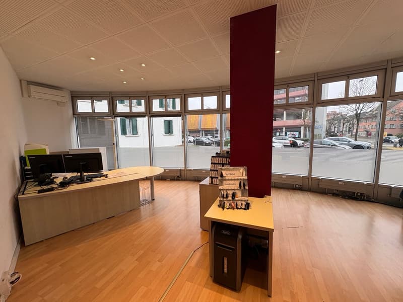 an office with desk, monitors, and cabinets