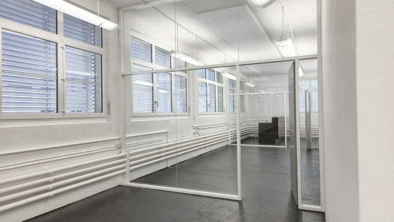 empty room with glass walls, long windows, grey floor, white walls