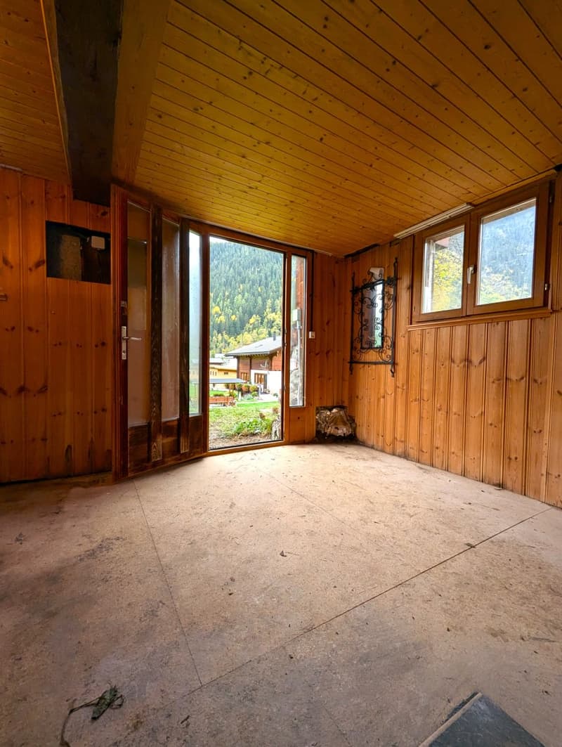 wooden walls, sliding glass doors, open to outdoor, view of mountain