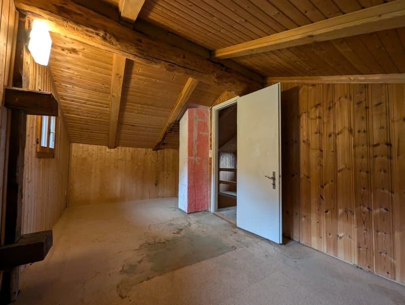 empty room, wooden walls, sloping ceiling, open door