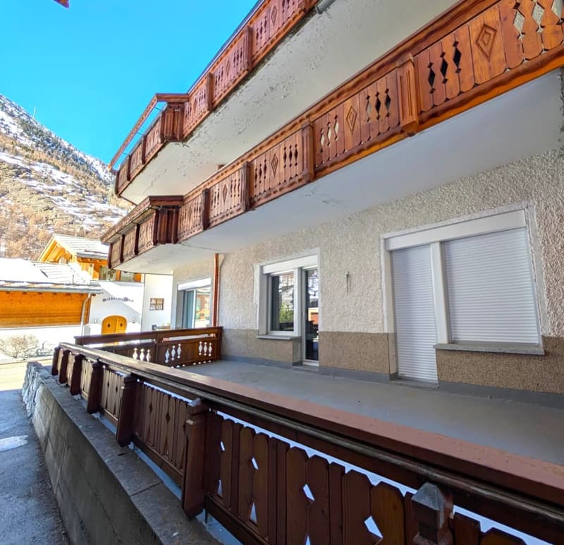 2 story house, balcony, white and brown exterior, window with blinds
