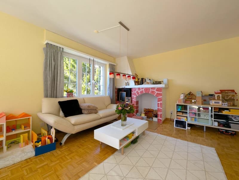 yellow walls, beige carpet, white couch, coffee table, white table lamp, fireplace