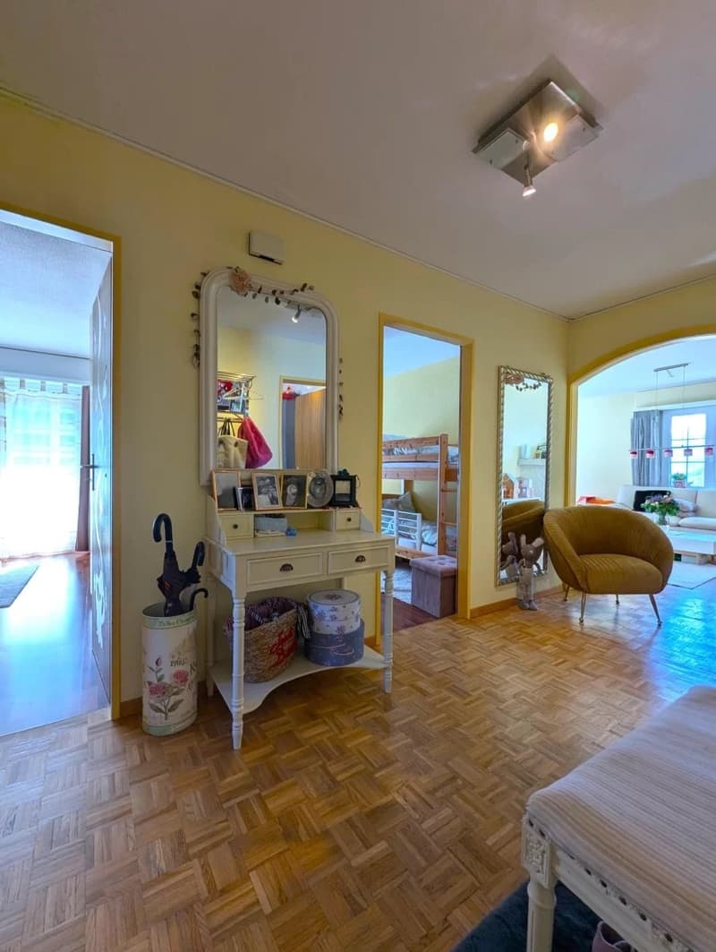 wooden parquet floor, yellow walls, white wooden desk, mirror, umbrellas, wooden bunk bed, decorative items