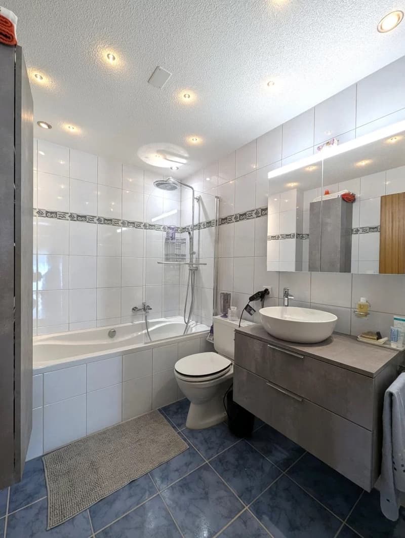 Bathroom with bathtub, toilet, sink, and shower