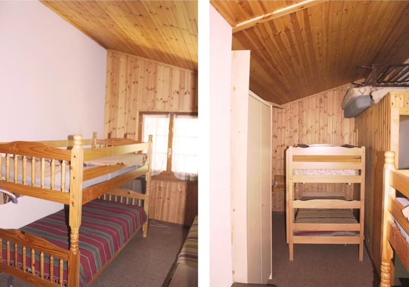 Rustic wooden cabin interior with bunk beds, wooden walls and ceiling, and striped bedding