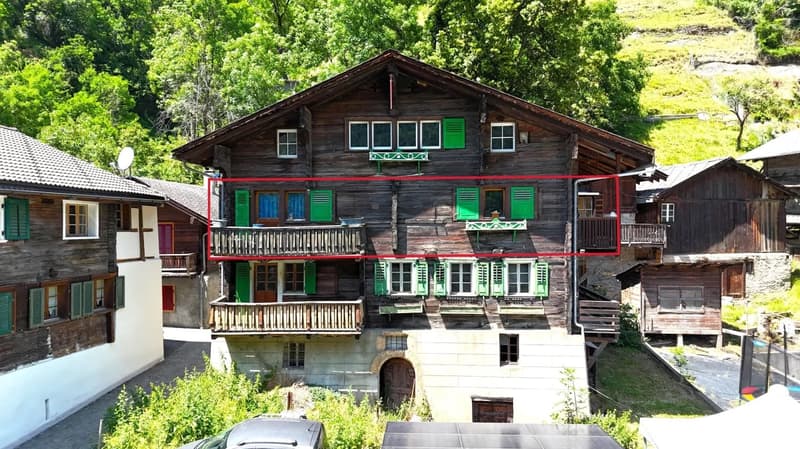 3-story house, wooden exterior, green shutters, balcony