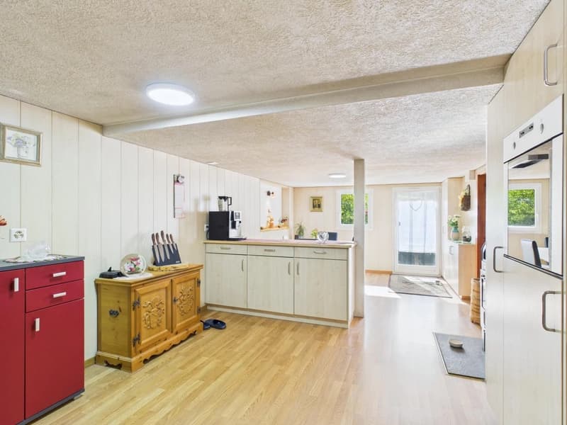 kitchen with kitchen island, gas stove, double doors, microwave, and windows