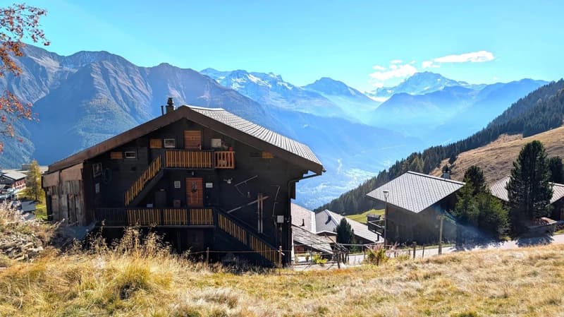 2 story wooden house, located in a mountainous region with beautiful views