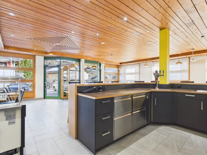 modern kitchen with wooden ceiling, stainless steel appliances, wooden countertop, white tile floor