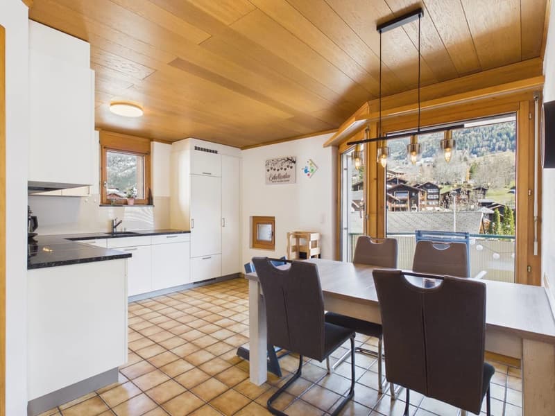kitchen with dining area, wooden ceiling, tiled floor, wooden dining table with chairs, balcony, sliding doors, mountain view