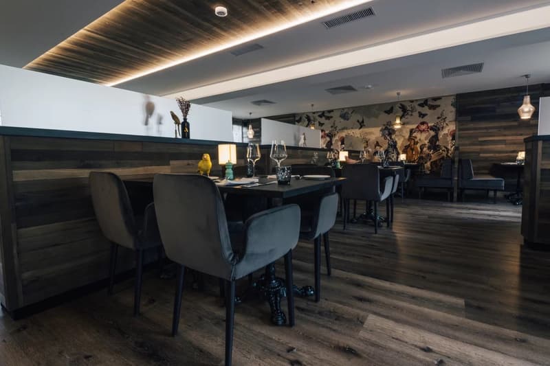 Wooden floor, wooden wall, dining tables, chairs, lamps, decorative items, mural