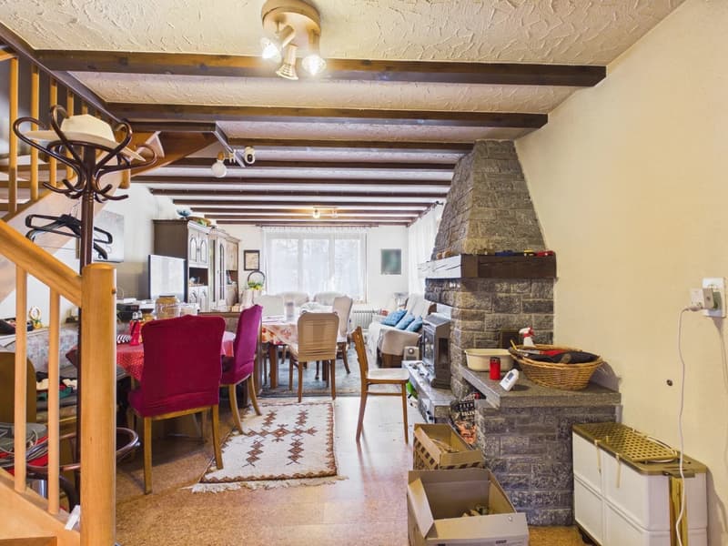dining area with dining table, chairs, fireplace, living room with couch, TV, cabinet, power outlet, wooden floor, wooden staircase, lamps