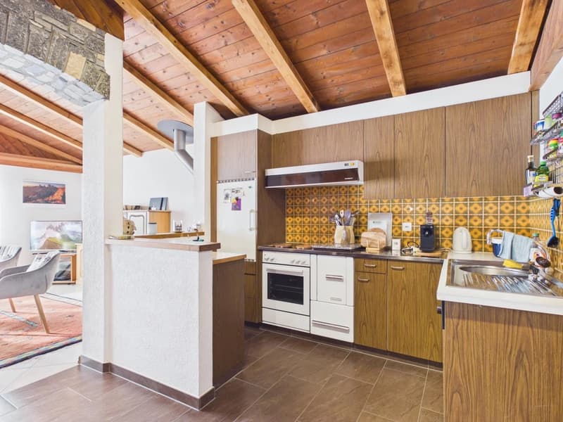modern kitchen with wooden cabinets, white appliances, wooden ceiling, tiled floor, sink, stove, refrigerator, countertop, artwork on wall