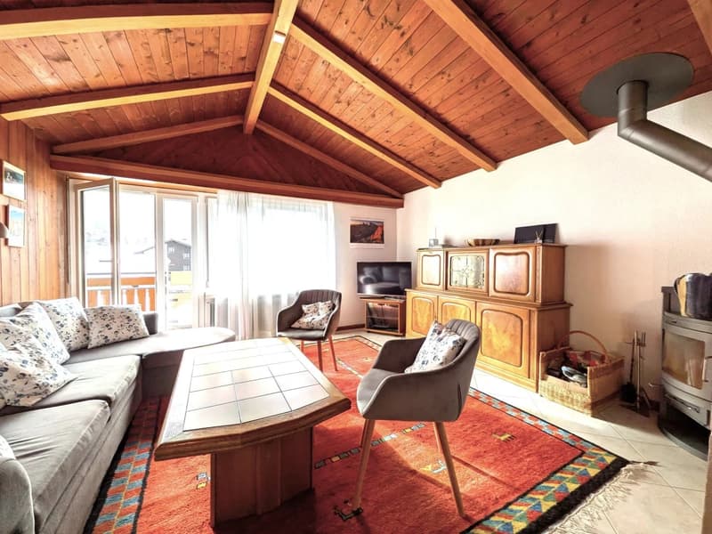 wooden ceiling, couch, coffee table, chairs, TV, cabinet, fireplace