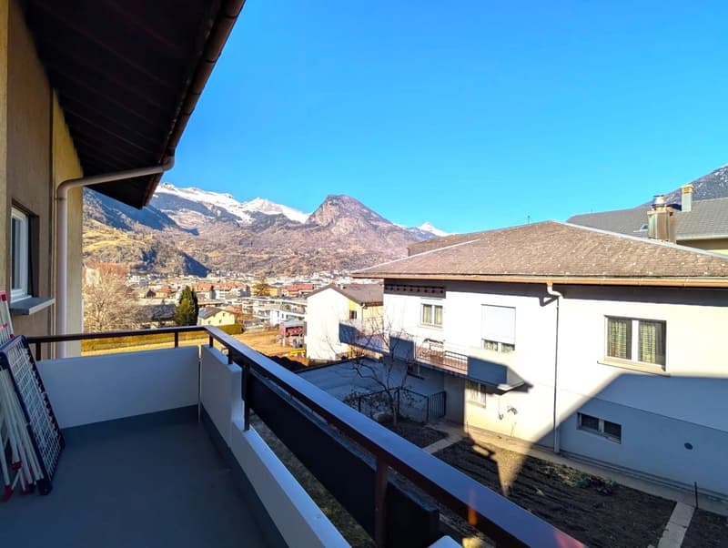Balcony with railings, view of mountains and town