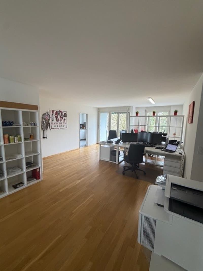 office room, white office desks, black office chairs, printer, computer, glass windows, wall mounted white shelves, hardwood floor