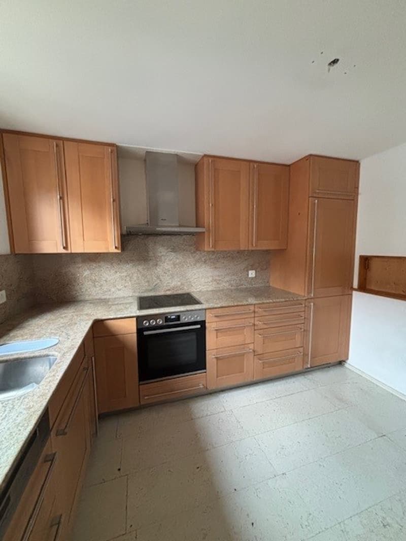 kitchen with oven, wooden cabinets, granite countertop, gas stove, marble floor