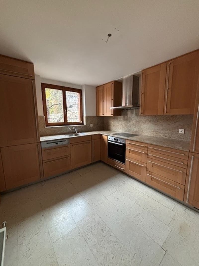 modern kitchen with white floor and wooden cabinets, sink, dishwasher, gas stove, and oven