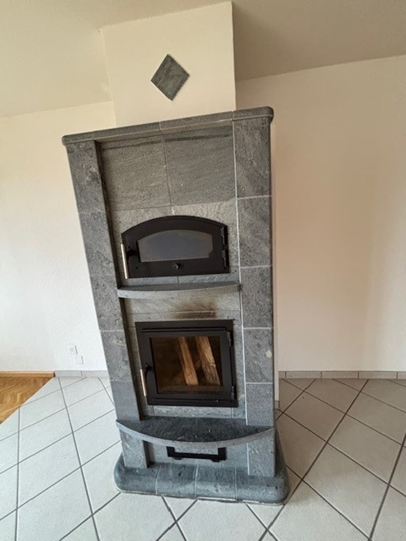 Fireplace, gray wall, white tiled floor