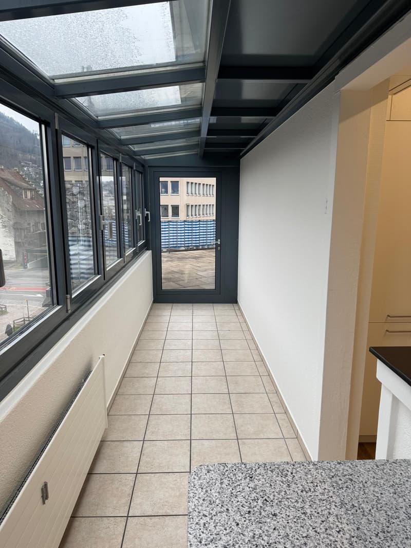 tiled floor, large windows, glass door, radiator, balcony