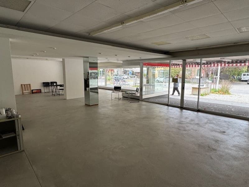 empty room with sliding glass doors, chairs, tables, person walking outside