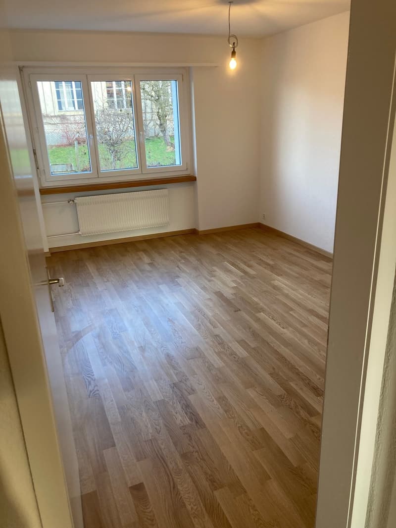 empty room, hardwood floors, large window, radiator