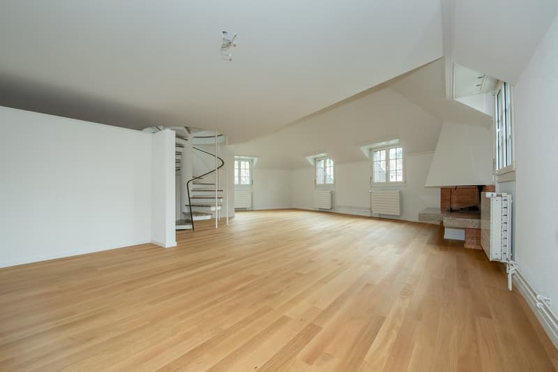 empty room, wooden floor, white walls, spiral staircase, fireplace, windows