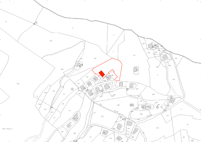 The image appears to be a floor plan or map of a residential area. It shows several buildings, roads, and other structures. The area highlighted in red appears to be a specific property or parcel of land.