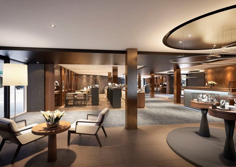 A modern interior featuring an open layout, wooden columns, gray carpet, white walls, large tables, white chairs, a small round table with a flower arrangement, a round carpet, and a desk with glass display cases.