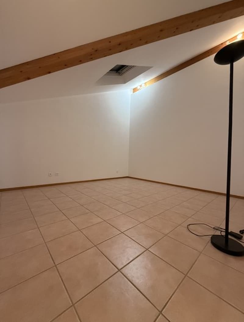 empty room, beige tiles, wooden ceiling, white walls, power outlet