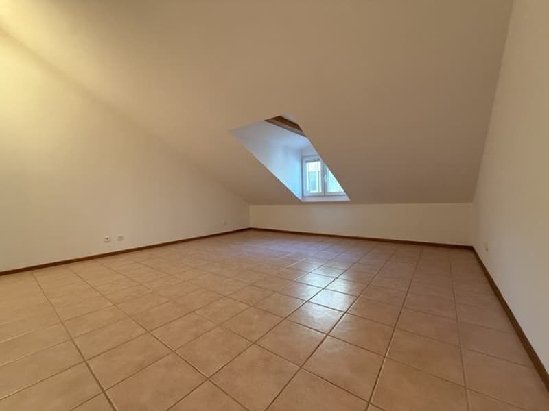 Empty room, tiled floor, attic windows, light colored walls