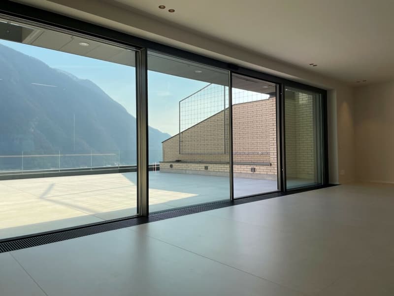 Floor-to-ceiling windows, balcony, wooden floor, clear view of mountains