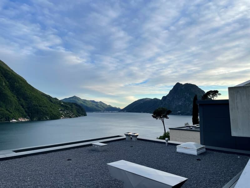 rooftop view, large lake, mountains, clear sky