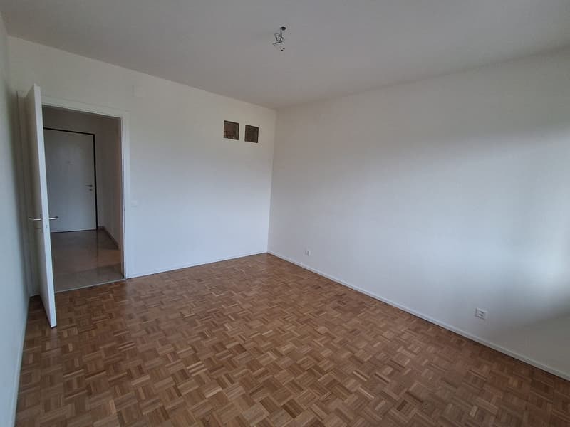 empty room, hardwood floors, white walls, power outlets, entrance, no furniture