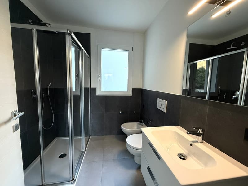 modern white sink, white tile flooring, walk-in shower, glass shower door, white bidet, white toilet, mirror