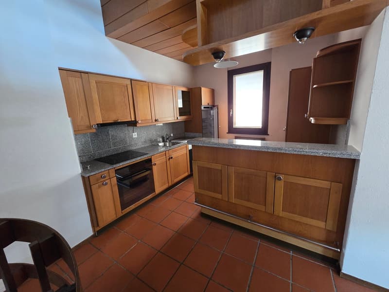modern kitchen with wooden cabinets, granite countertops, black stove, oven, sink, window, tiled floor