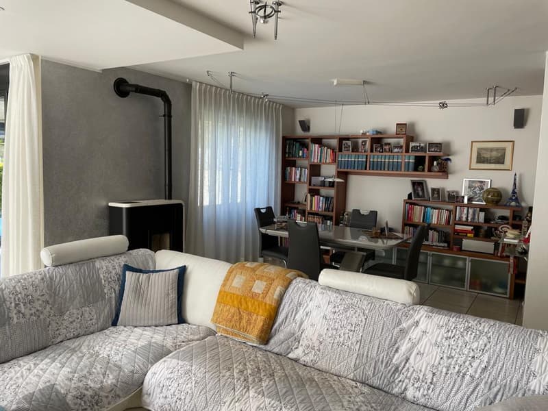 L-shaped sofa, fireplace, bookshelves, dining table, chairs, picture frames, speakers, curtains