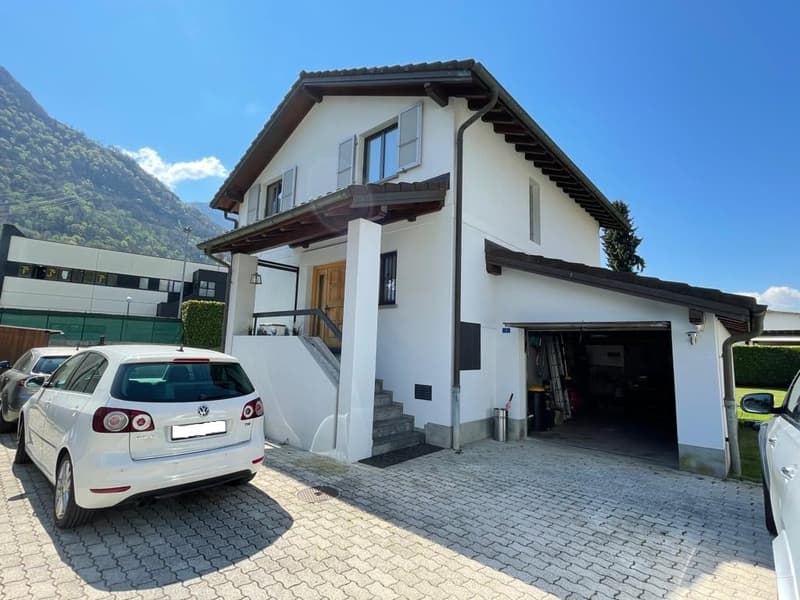 2 story house, white exterior, brown roof, garage, mountain view