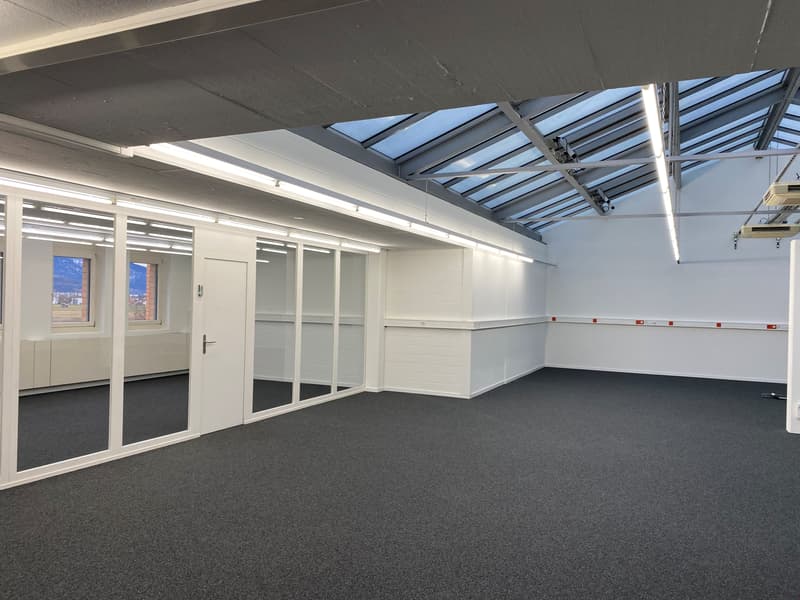 empty office space, large windows, glass partitions, bright lighting, tiled floor