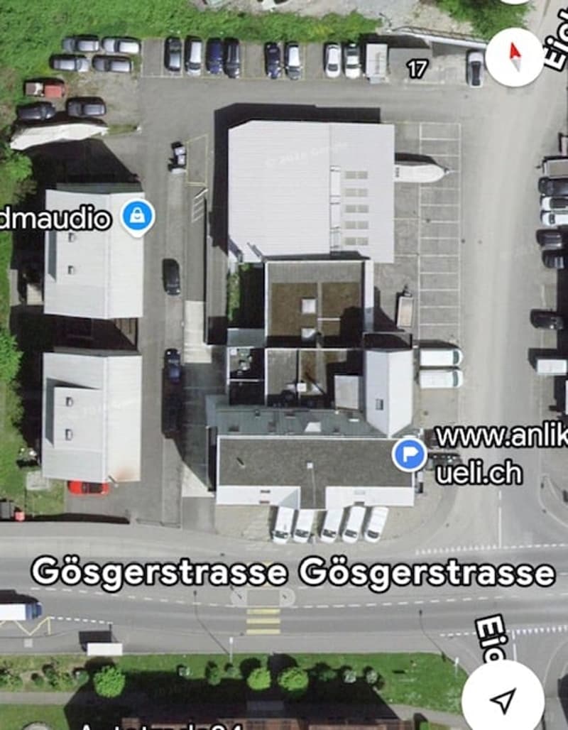 Top-down view of a multi-level building with parking spaces, labeled "Göserstrasse" and showing surrounding structures.